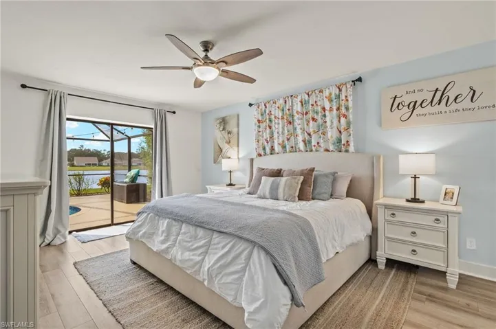 Bedroom featuring light hardwood / wood-style flooring, access to exterior, and ceiling fan