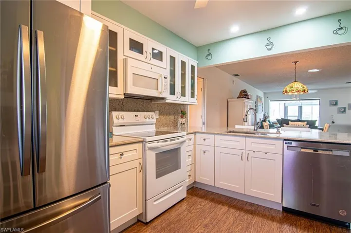 This attractive updated Kitchen features soft close  modern cabinets and granite counter tops.