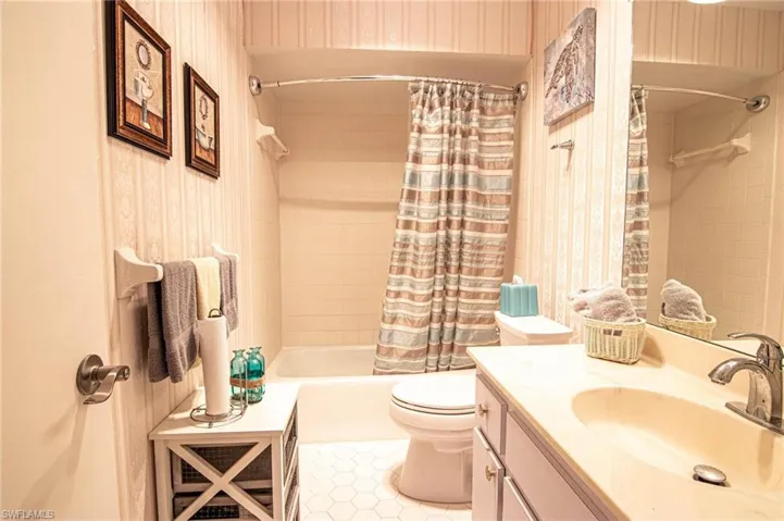 This guest bathroom is located off the dining/family area and is pleasantly decorated!