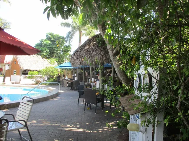 View of patio / terrace featuring a community pool and outdoor dining area