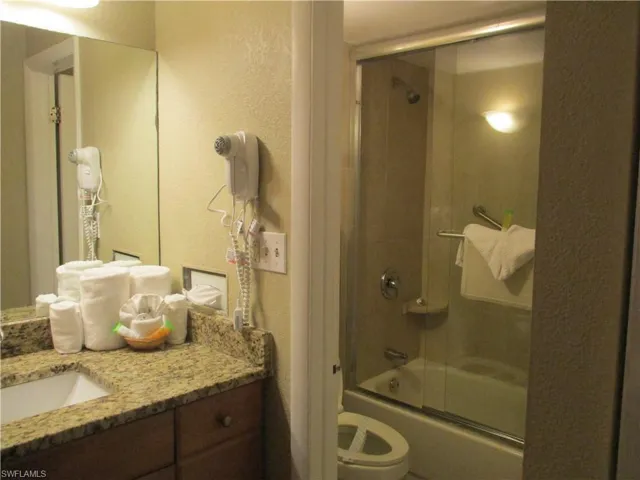 Bathroom with enclosed tub / shower combo