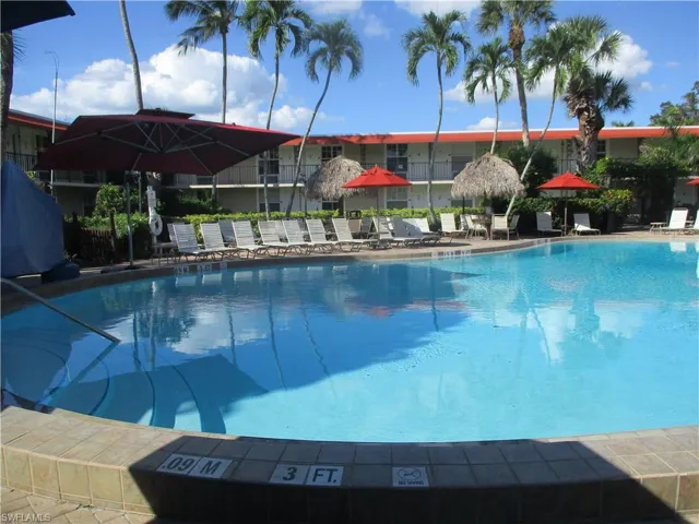 Community pool with a patio