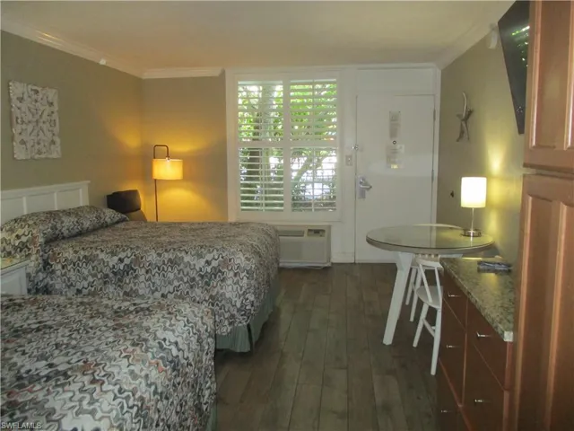 Room with 2 Queen beds, table and 2 chairs, a recliner and plenty of cabinet and closet space