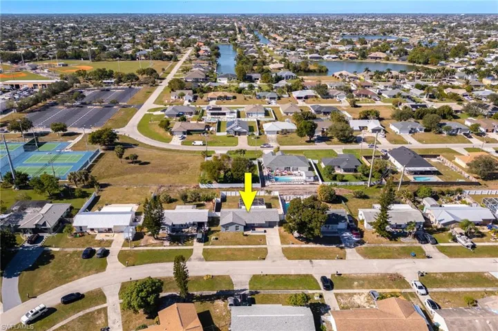 Aerial view of property's location featuring nearby suburban area and a nearby body of water