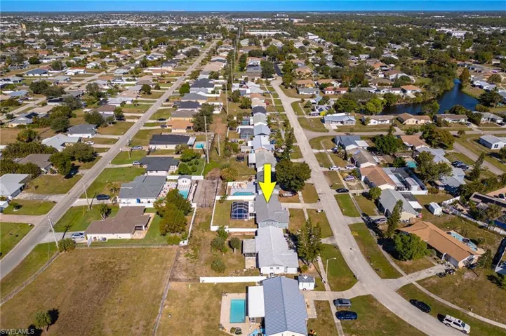 Aerial view of property's location featuring nearby suburban area