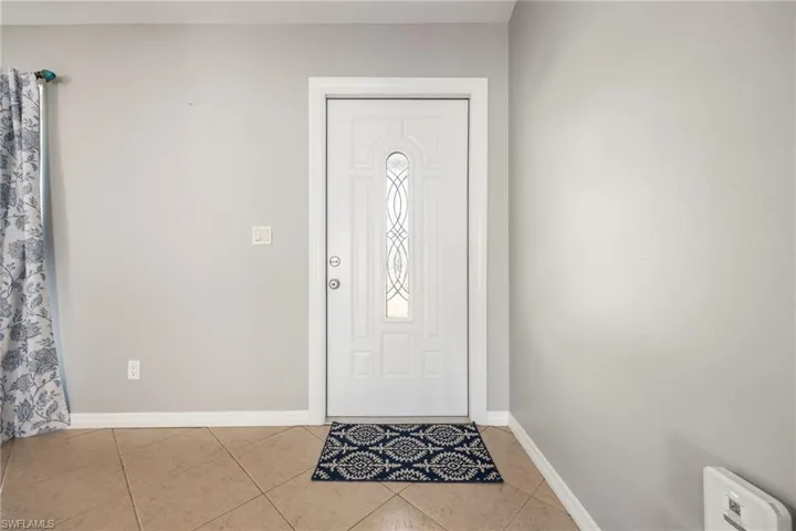 Tiled entryway with baseboards