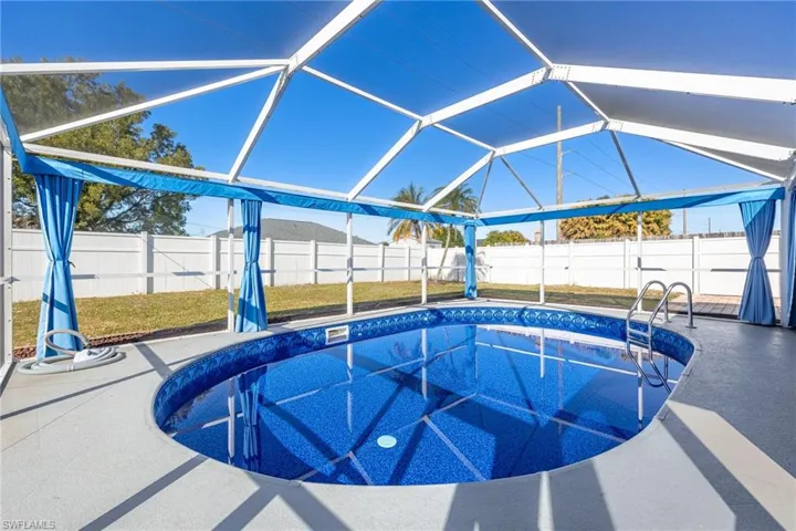 View of swimming pool with a lanai, a fenced backyard, and a sunroom