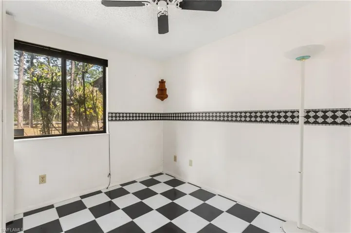 Spare room with tile patterned floors, a textured ceiling, and ceiling fan