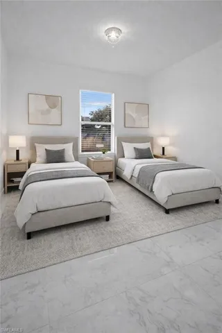 Bedroom featuring marble look tile flooring