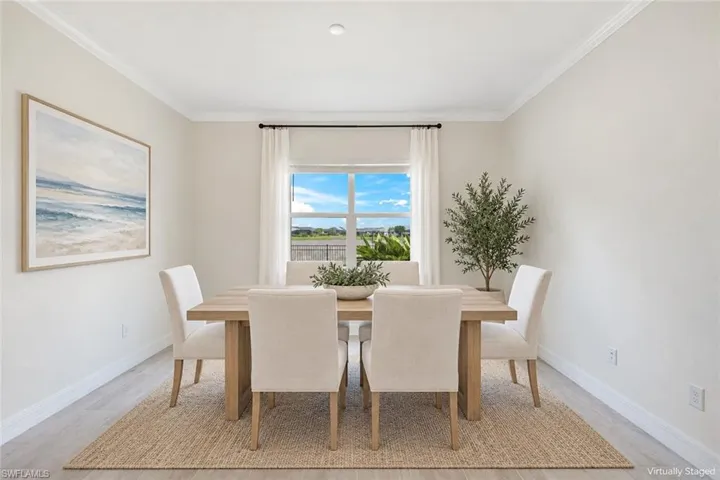Virtual Staging Neutral wall tones, crown molding, single-hung window with exterior landscape, and wood-finish flooring