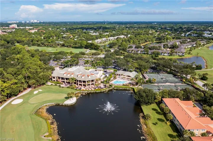 Golf course flanked by lakes and fountains
