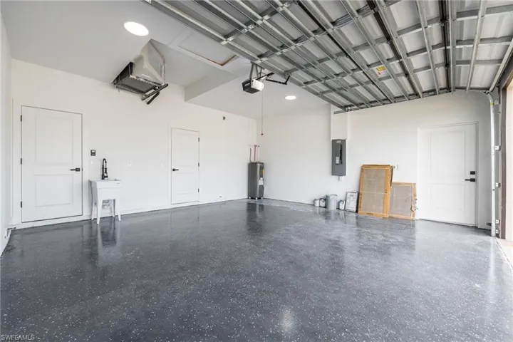 Garage with water heater and electric panel