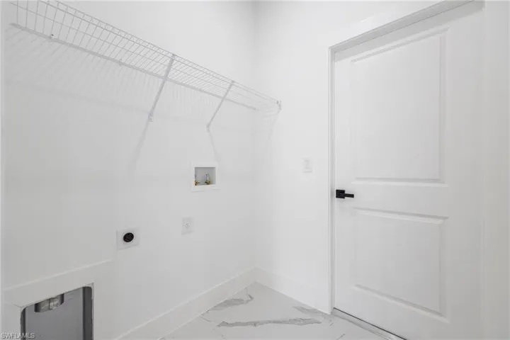 Laundry room with light marble finish flooring, electric dryer hookup, and hookup for a washing machine