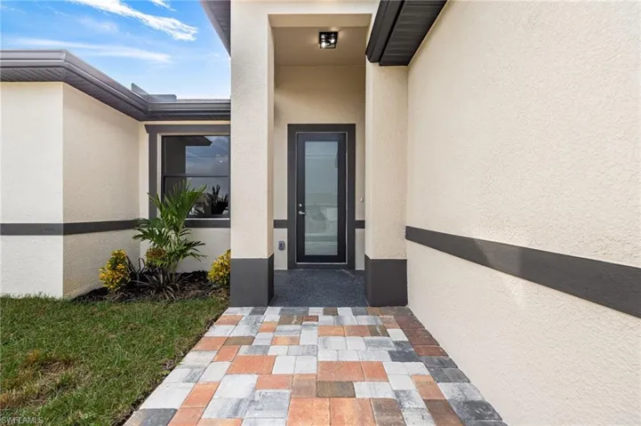 Property entrance featuring stucco siding