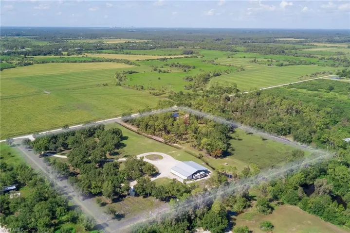 Aerial view of property's location with a forest