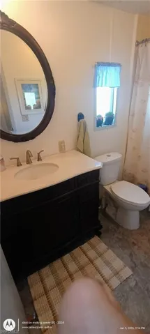 Bathroom featuring vanity and curtained shower