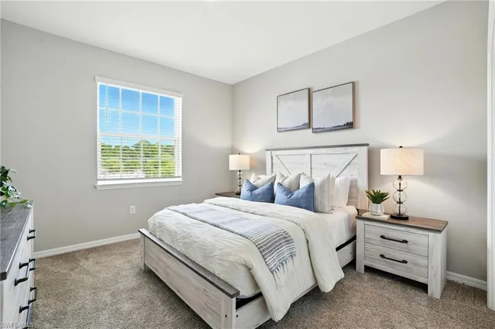 Bedroom with light colored carpet