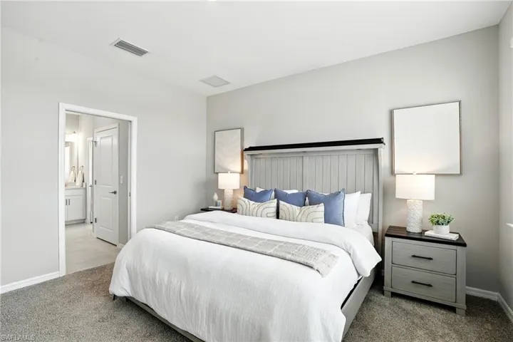 Bedroom featuring carpet floors and connected bathroom
