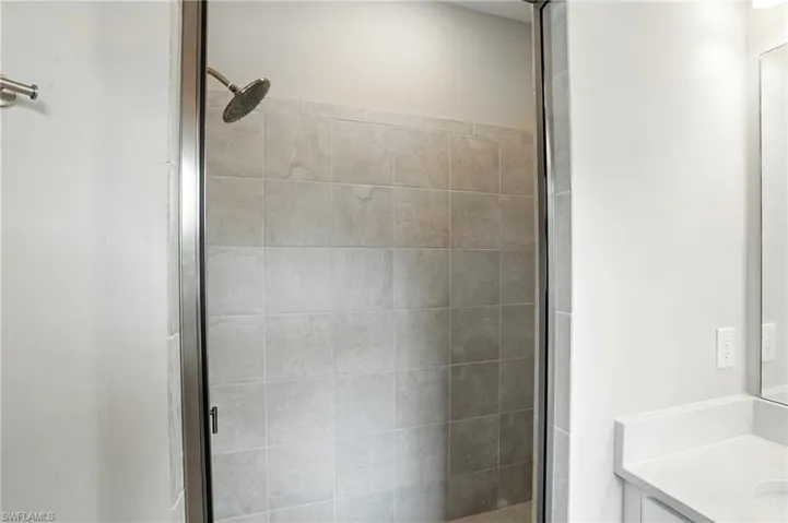 Bathroom featuring a shower stall and vanity