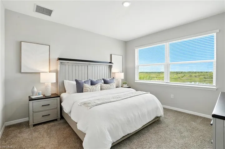 Carpeted bedroom featuring baseboards