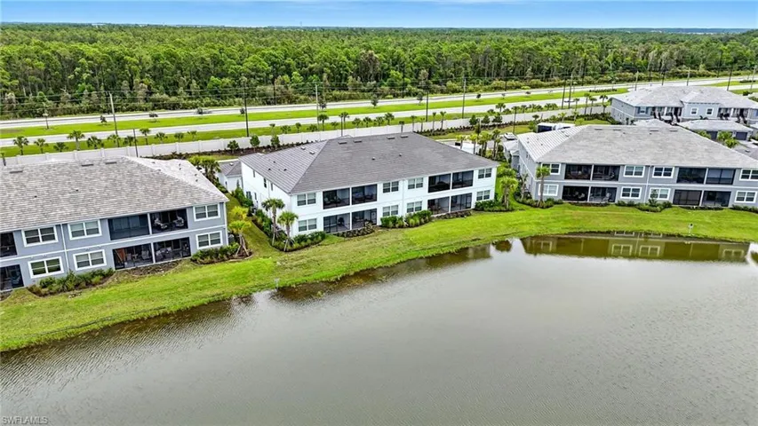 Aerial view of a heavily wooded area and a nearby body of water