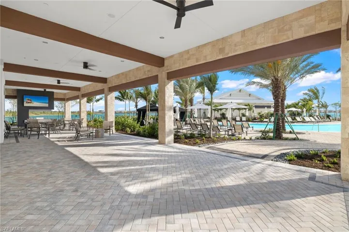 View of patio / terrace with ceiling fan and a community pool