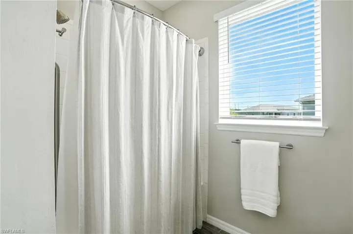 Bathroom with plenty of natural light and a stall shower