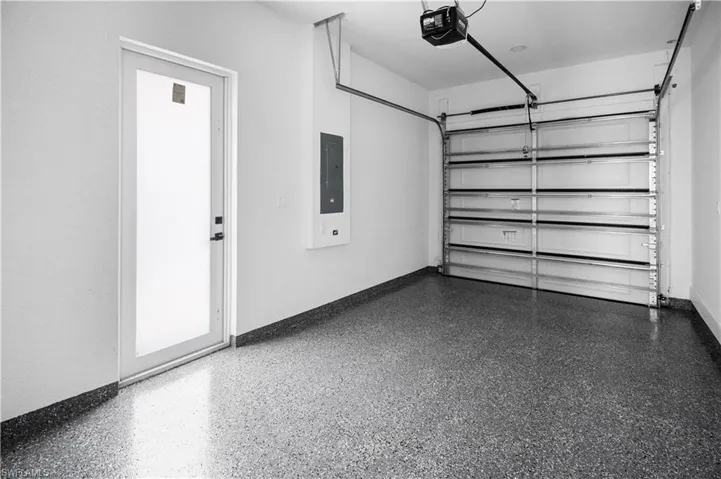 Garage with a garage door opener and electric panel