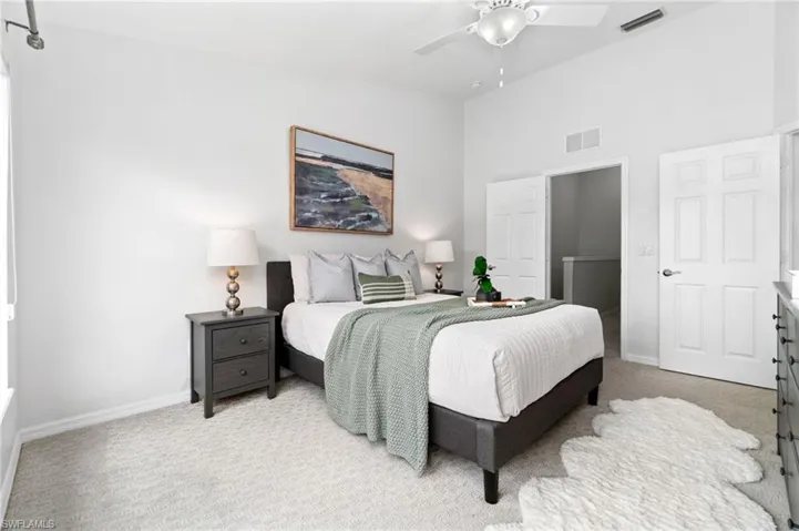 Carpeted bedroom with ceiling fan