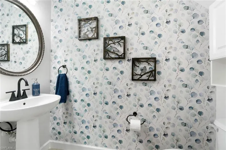Downstairs half bath featuring pedestal sink