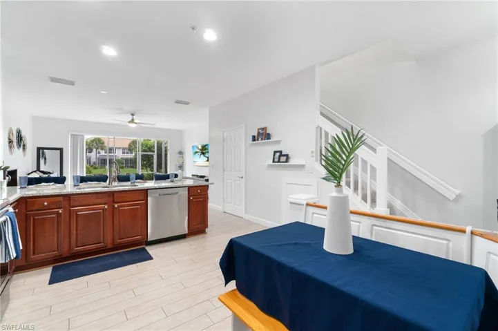 Kitchen featuring dishwasher, light stone countertops, and custom, corner table