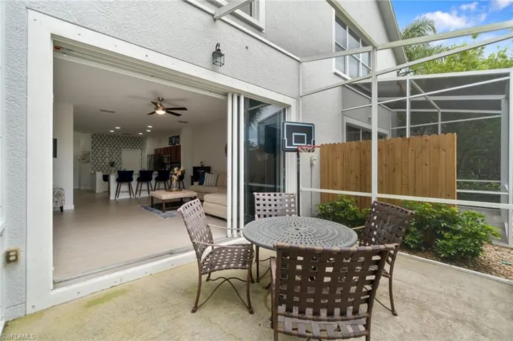View of patio featuring a lanai and ceiling fan