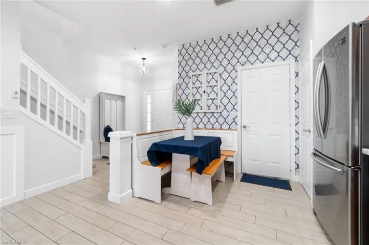 Kitchen featuring dishwasher, light stone countertops, and custom, corner table