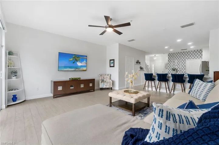 Wood-like tile flooring brightens the living area while the breakfast bar offers a place for dining