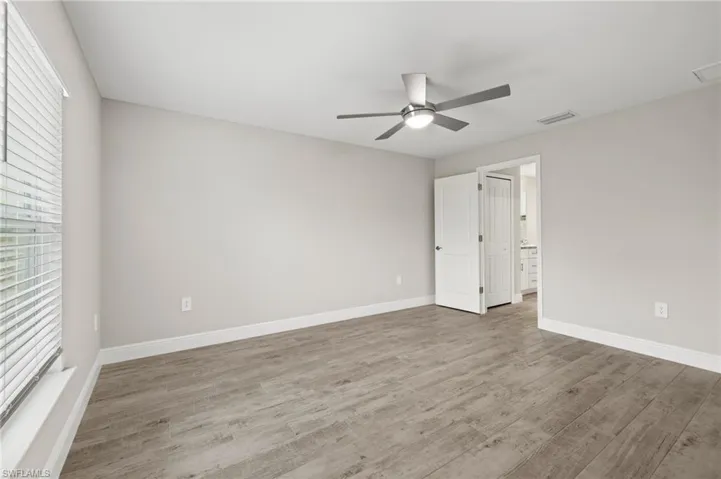 Spare room featuring ceiling fan and hardwood / wood-style floors