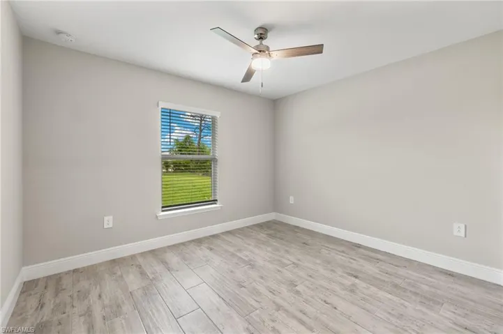 Spare room with ceiling fan and light hardwood / wood-style flooring