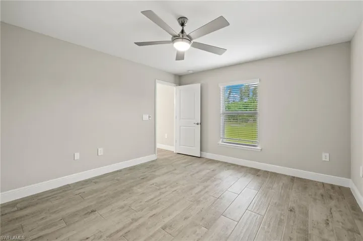 Spare room featuring ceiling fan and light hardwood / wood-style flooring
