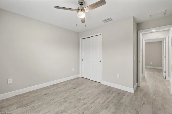 Unfurnished bedroom with a closet, ceiling fan, and light hardwood / wood-style flooring