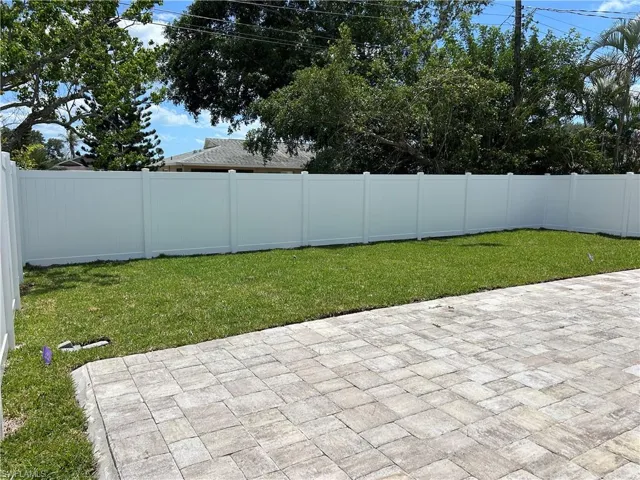 New Backyard with green grass and privacy fence.