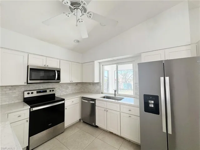 New white shaker cabinetry and quartz countertops plus new appliances