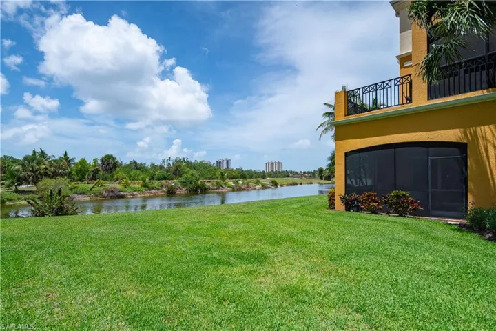 View of yard featuring a balcony and a water view