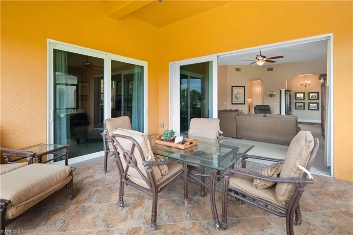 View of patio with outdoor lounge area and ceiling fan