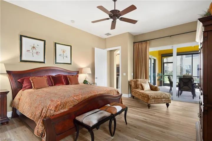 Bedroom featuring access to exterior, light wood-type flooring, and ceiling fan
