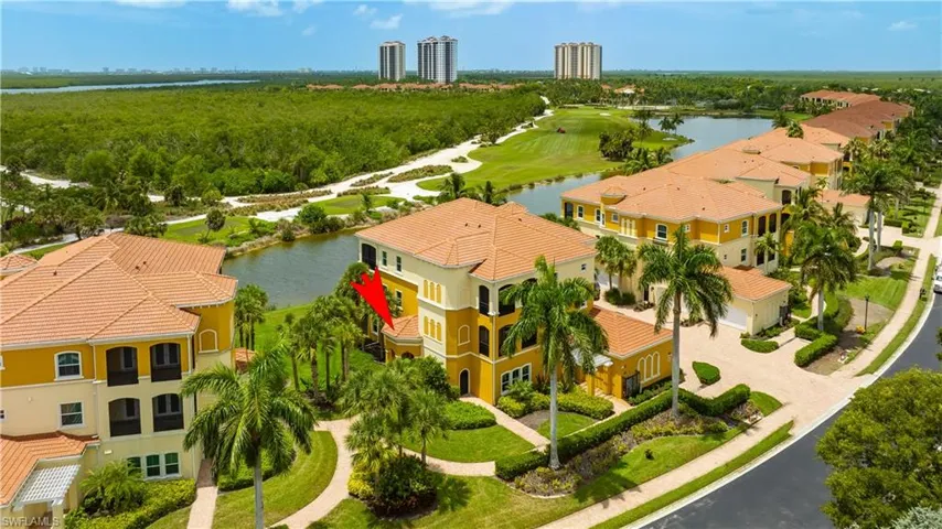 Birds eye view of property with a water view