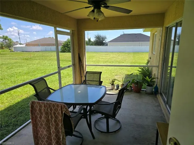Sunroom / solarium with ceiling fan, outdoor dining area, and plenty of natural light