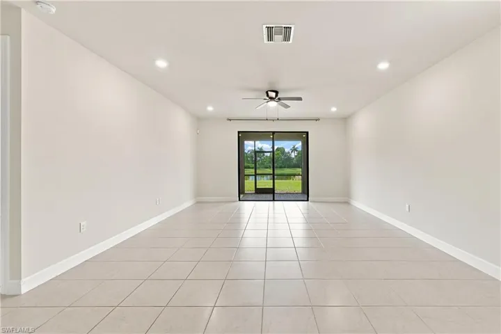 Recessed ceiling lighting, ceiling fan, sliding glass doors, screened patio, and tile flooring