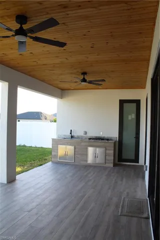 View of patio / terrace with area for grilling, a ceiling fan, and a sink