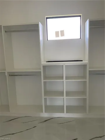 Spacious closet with marble finish floor