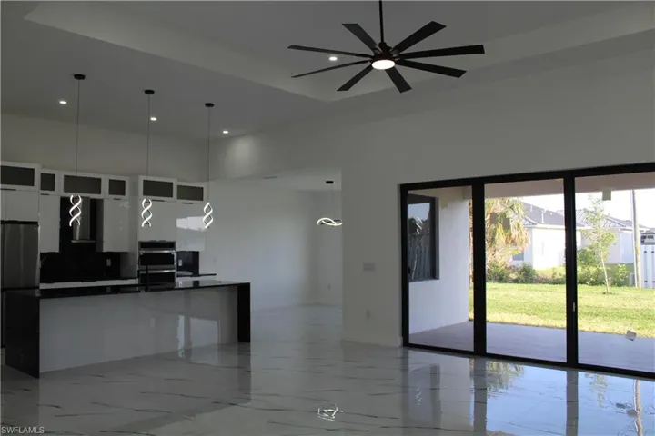 Kitchen featuring dark countertops, white cabinetry, modern cabinets, ceiling fan, and recessed lighting