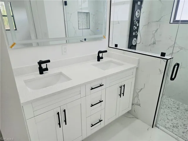 Dual vanity with white cabinetry and quartz countertops